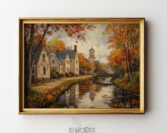 May include: A framed landscape painting depicts a serene autumn scene. The artwork showcases a canal with reflections of buildings and trees in fall colors. A bridge and a church tower are visible in the distance. The frame is gold, and the artwork is signed "ELM TREE PRINTS".