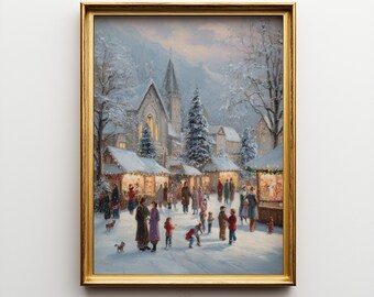 May include: A framed print of a winter scene with a Christmas market. The artwork depicts a snow-covered town square with people, market stalls, a church, and evergreen trees. The frame is gold.
