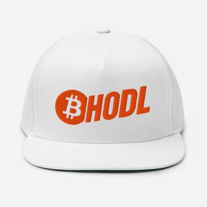 May include: White flat-brimmed baseball cap with an orange Bitcoin symbol and the word "HODL" in orange block letters. The cap has a structured fit and a flat visor, suitable for casual wear.