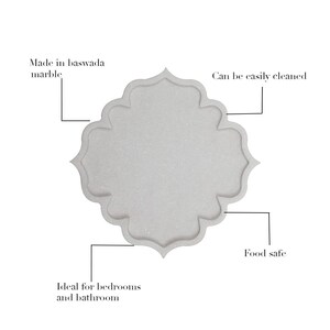 May include: A white marble tray with a scalloped edge. The text on the image says it is made of baswada marble, can be easily cleaned, is food safe, and ideal for bedrooms and bathrooms.