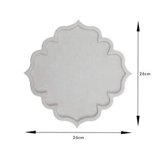 May include: A light gray decorative tray with a scalloped edge. The tray is 26 cm (10.2 inches) wide and 26 cm (10.2 inches) tall. The tray has a textured surface and a symmetrical design.