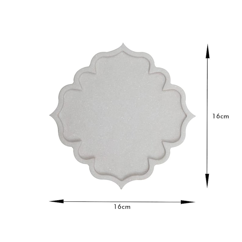May include: A light gray, decorative tray with a unique, scalloped quatrefoil shape. The tray measures 16cm by 16cm, or approximately 6.3 inches by 6.3 inches. The tray has a textured surface and is suitable for home decor.