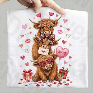 May include: A white fabric with a Valentine's Day design featuring three brown Highland cows stacked on top of each other. The cows have heart-shaped sunglasses, bows, and hold a balloon that says "XOXO". Hearts and gifts are scattered around.