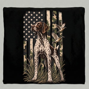 May include: A square throw pillow featuring a German Shorthaired Pointer standing in tall grass. The background displays a stylised American flag with a camouflage pattern. Two ducks are depicted in flight on the right side of the design.