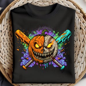 May include: Black crewneck sweatshirt featuring a Halloween-themed graphic. The design showcases a split pumpkin-baseball with glowing eyes and a menacing grin, crossed with orange and teal baseball bats. Colorful paint splatters surround the central image.