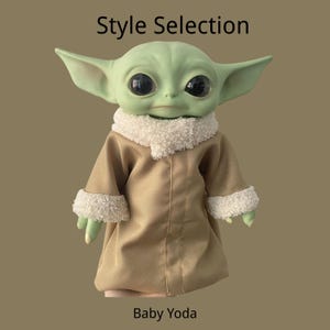 May include: A green creature figurine with large black eyes and pointed ears, wearing a tan coat with a white fuzzy collar and cuffs. The text Style Selection is at the top and Baby Yoda is at the bottom of the image against a brown background.
