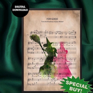 May include: Framed print with sheet music and watercolour silhouettes of two witches from the musical "Wicked." The text "FOR GOOD" and "DIGITAL DOWNLOAD" are visible. A green "SPECIAL BUY!" sticker is in the bottom right corner.