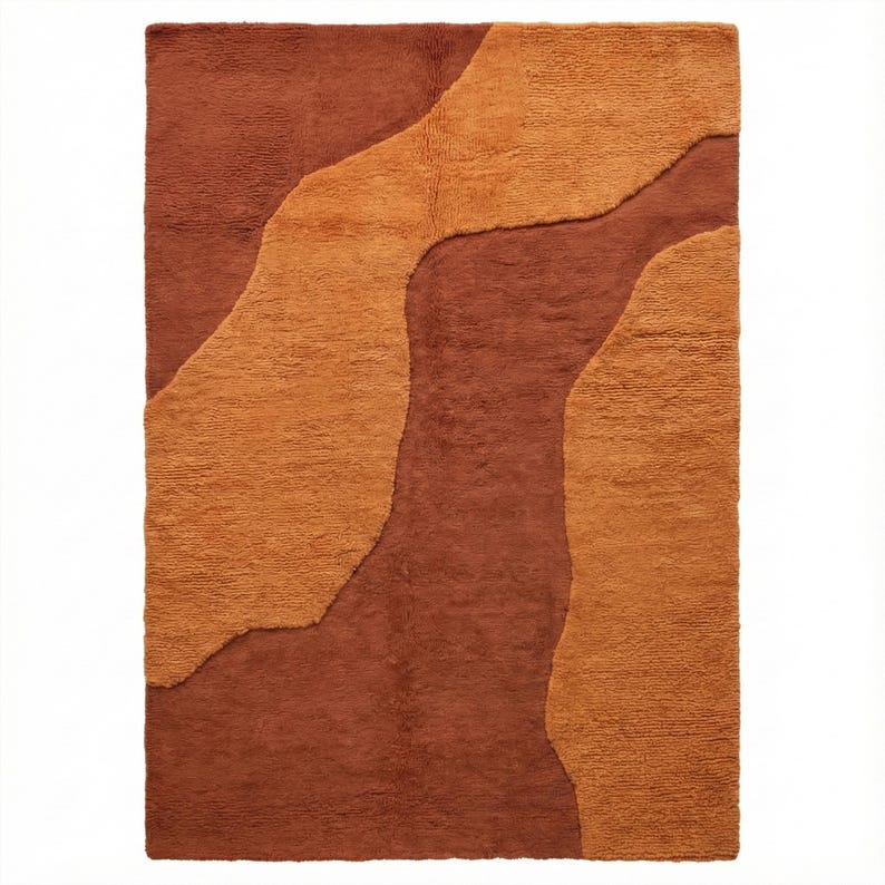 Rectangular hand-tufted wool rug in terracotta brown and warm mustard ochre, featuring flowing organic abstract shapes and a textured high-low surface.