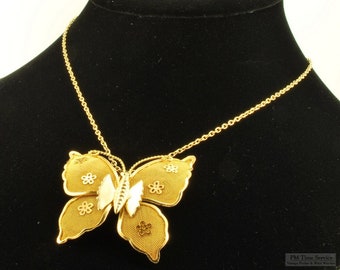 Vintage gold-toned butterfly pendant, accented with small 5-petal flowers, with a matching 16" necklace