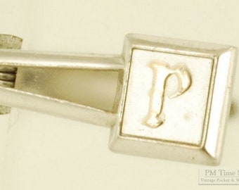 Swank silver plate tie clip with a gold "P" monogram, elegant cut-out "V" design