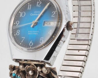 Caravelle by Bulova Electronic Set-O-Matic wrist watch w/ day and date, chrome & stainless steel case, hand-crafted silver + turquoise band