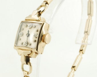 Montre-bracelet vintage pour femme Hilton, 17 rubis, joli boîtier Bulova en or jaune (rempli) avec une lunette étroite, cristaux facettés