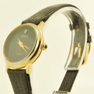 Genevex quartz ladies' wrist watch, museum style, attractive round gold-toned & stainless steel case image 1