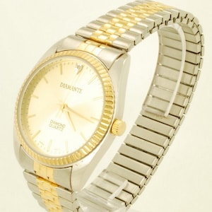 Diamante quartz wrist watch, heavy gold-toned & stainless steel cushion-shaped case, matching expansion band, boxed