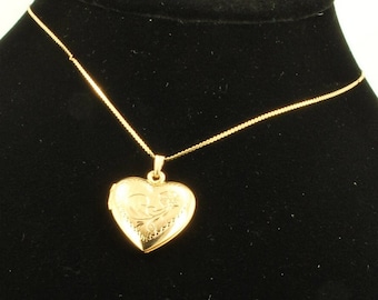 Yellow gold plated heart-shaped locket with a matching 15.5" serpentine-link necklace, elaborate engraved flower