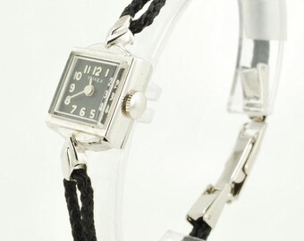 Timex vintage ladies' wrist watch, elegant silver-toned & stainless steel rectangular case, fancy chevron style extended lugs