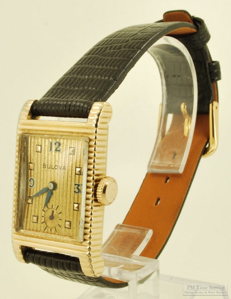 Bulova vintage grade 7AK 49 wrist watch, 21 jewels, distinctive yellow gold filled rectangular case with a scalloped design image 1