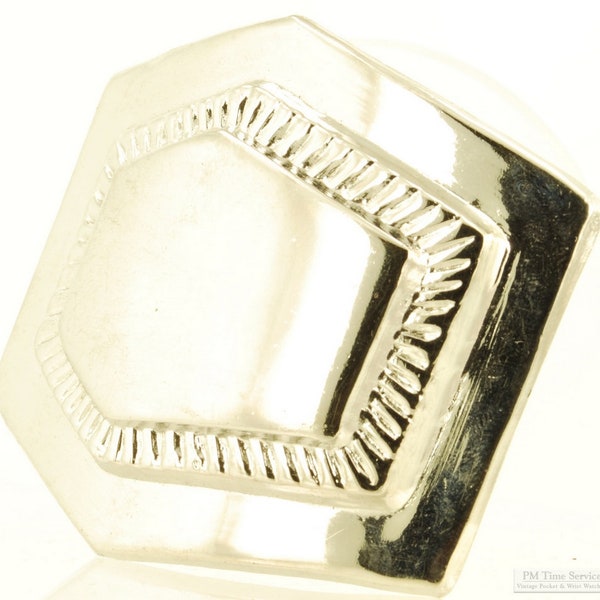 Silver-toned belt buckle, asymmetrical 6-sided shape with a raised center detail