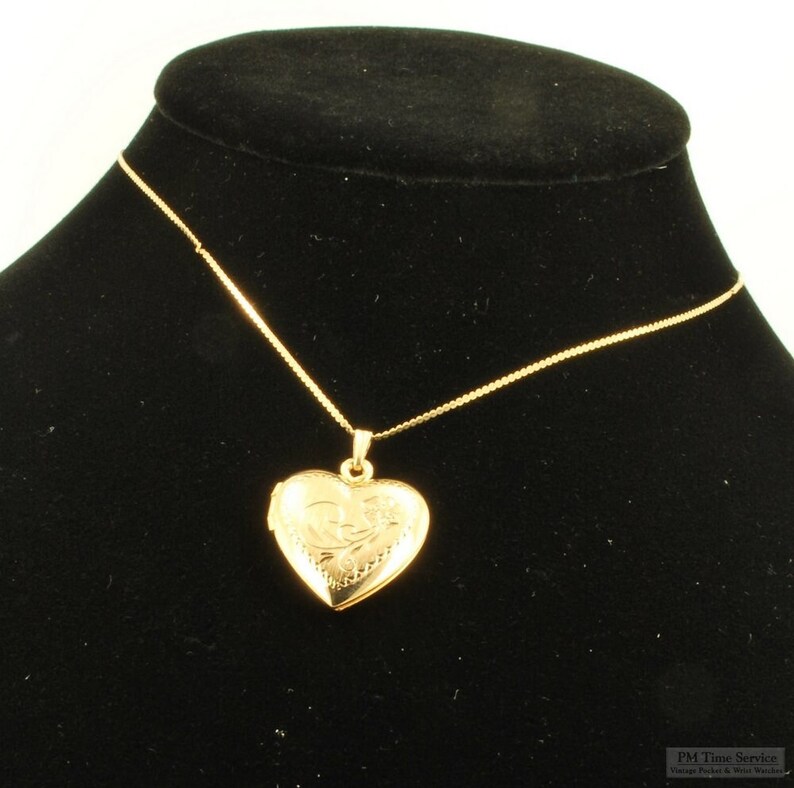 Yellow gold plated heart-shaped locket with a matching 15.5 serpentine-link necklace, elaborate engraved flower image 1