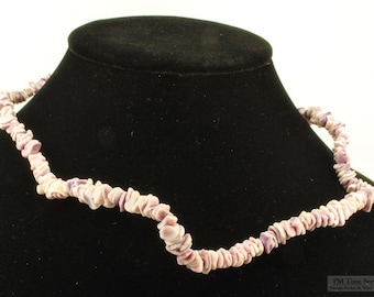 24" lavender shell necklace with small honey-colored glass beads and a brass barrel-style clasp