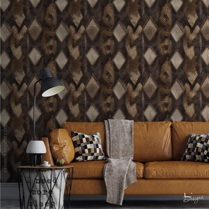 May include: A brown leather sofa with two checkered throw pillows and a gray throw blanket, positioned against wallpaper featuring a dark brown diamond pattern. A black desk lamp sits on a wire side table with the text I need more sleep.