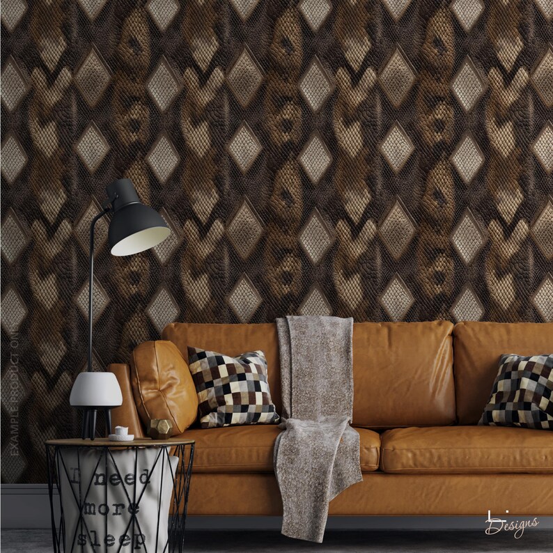 May include: A brown leather sofa with two checkered throw pillows and a gray throw blanket, positioned against wallpaper featuring a dark brown diamond pattern. A black desk lamp sits on a wire side table with the text I need more sleep.