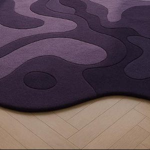 Hand tufted irregular purple abstract wool rug with wavy layered design, modern statement carpet for living room décor"