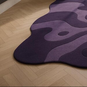 Hand tufted irregular purple abstract wool rug with wavy layered design, modern statement carpet for living room décor"