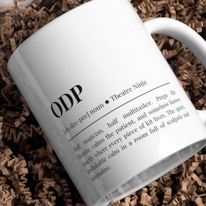 May include: White ceramic mug with the word "ODP" in large black letters. The mug features a definition of "ODP" as "Theatre Ninja" with a description of the role. A great gift for anyone in the medical field.