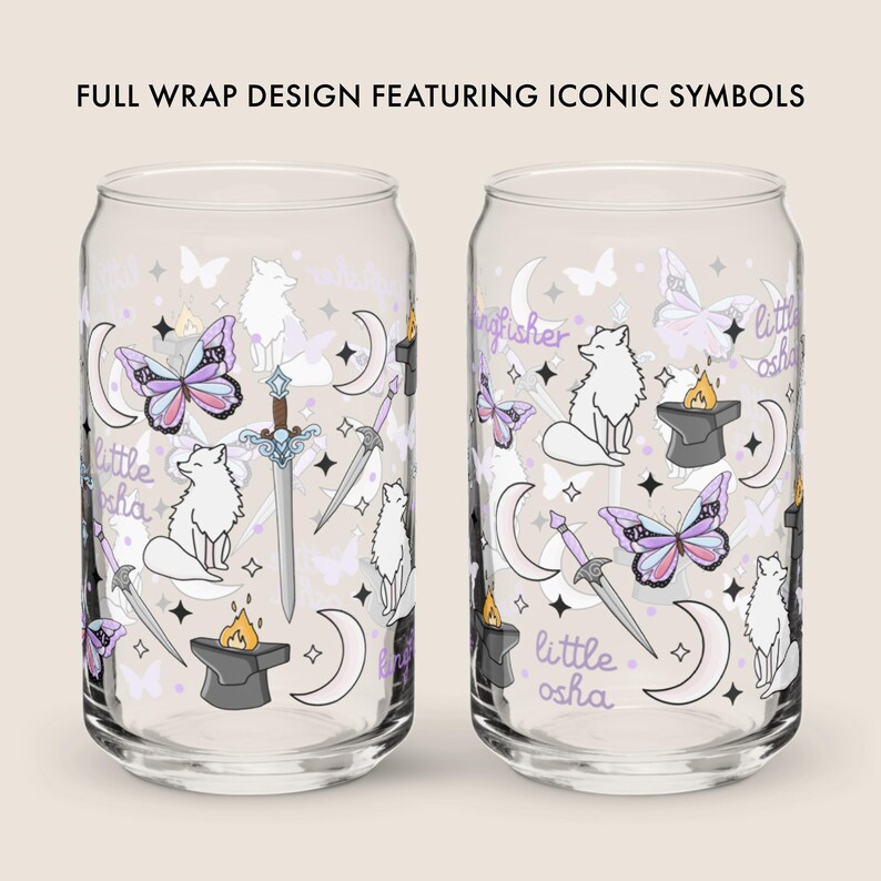 May include: Two clear glass can-shaped cups with a wraparound design featuring iconic symbols. The design includes butterflies, crescent moons, swords, foxes, and text that reads "little osha" and "kingfisher". The cups are decorated with purple, white, and gold accents.