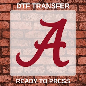 May include: A DTF transfer featuring a large, dark red letter A in a classic serif font. The text DTF TRANSFER is printed at the top and READY TO PRESS is printed at the bottom in white capital letters against a light, semi-transparent square.