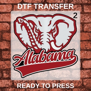 May include: A DTF transfer sheet featuring a graphic of an elephant head in white and maroon with the text Alabama in a script font below it. The design includes the number 2 in the top right corner and the text DTF TRANSFER and READY TO PRESS.