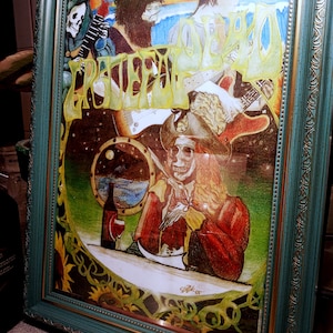 May include: A framed, colorful artwork featuring a skeleton in a pirate hat, holding a fork and knife, with a bottle and glass of wine. The artwork has the word "Grateful" in yellow and green lettering. The frame is teal with gold accents.