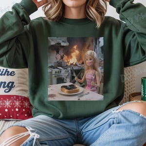 May include: A white ceramic mug with a black handle and the text "But First, Coffee" in a bold, black font. The mug is set against a blurred background, suggesting a cozy setting.