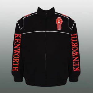 May include: Black zip-up jacket with white trim and red lettering. The word "KENWORTH" is printed vertically on both sleeves. The Kenworth logo is on the chest. The jacket has a high collar.