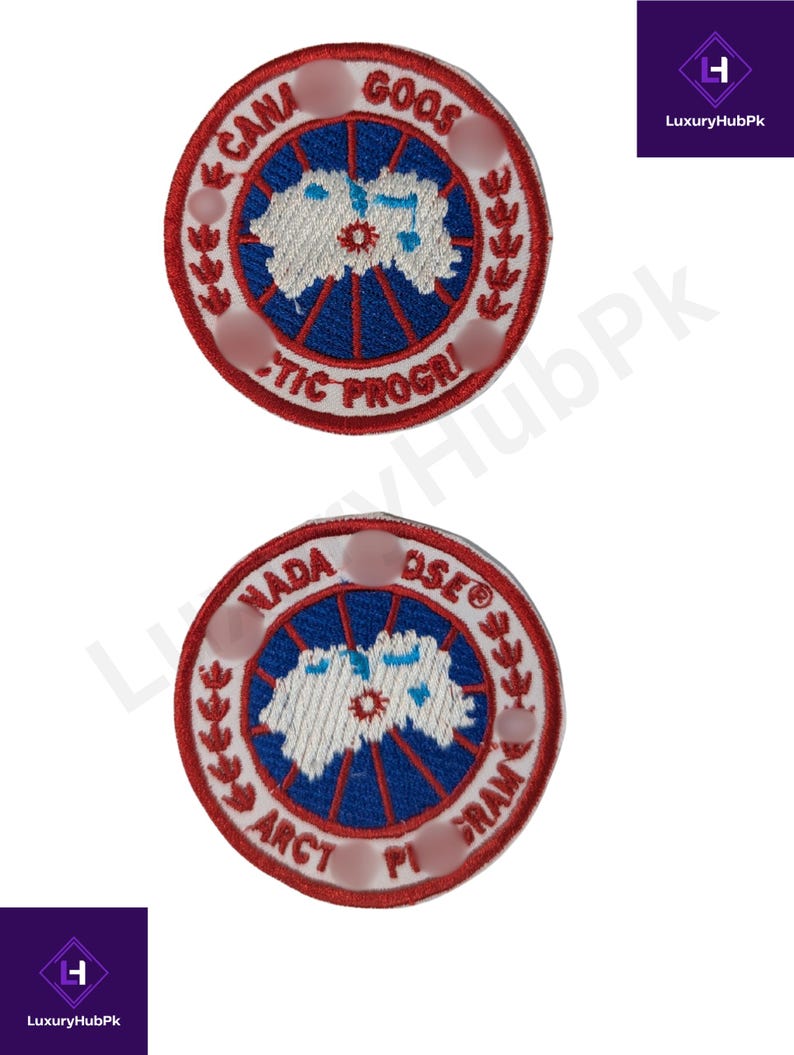 May include: Two circular embroidered patches with a red border and white text. The patches feature a blue and white design in the center, with the words "CANA GOOS ARCTIC PROGRI" and "NADA OSE ARCT PI GRAM" around the edges.