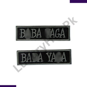 May include: Two rectangular black patches with white embroidered text. The top patch reads "B BA AGA" and the bottom patch reads "BA A YA A". Each patch has three gray, circular embellishments.