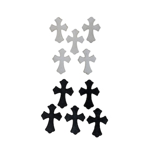 以下が含まれることがあります： 白と黒の装飾的な十字架のコレクション。白い背景に配置されています。十字架はシンプルで対称的なデザインで、さまざまなクラフトプロジェクトや装飾に適しています。