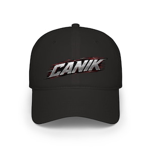 May include: A black baseball cap featuring the word CANIK printed in a metallic silver font with a brushed texture and red motion-blur accents. The cap has a structured crown, a curved brim, and a button at the top center of the head panel.