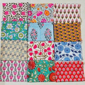May include: A collection of twelve square fabric swatches arranged in a grid, each featuring distinct floral and botanical block-print patterns in vibrant colors including pink, blue, yellow, green, and red on white or colored backgrounds.