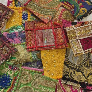 May include: A collection of rectangular fabric patches featuring intricate embroidery, metallic gold thread, sequins, and beadwork. The patches display a variety of vibrant colors including yellow, red, green, blue, and pink, with diverse patterns.