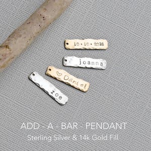 May include: Four personalized silver and gold bar pendants with hammered textures. The pendants are engraved with the names "zoe", "Daniel", "joanna", and the date "10.10.2016". The text "ADD - A - BAR - PENDANT Sterling Silver & 14k Gold Fill" is displayed below the pendants.