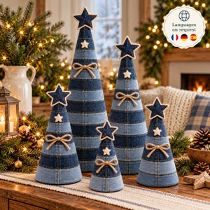 May include: A set of five cone-shaped decorative trees crafted from alternating horizontal bands of dark and light blue denim fabric. Each tree is topped with a dark blue denim star, features a small white fabric star, and a jute twine bow.
