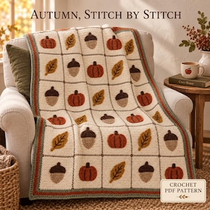 May include: A cream-colored crochet blanket featuring a grid pattern with alternating motifs of orange pumpkins, brown acorns, and yellow leaves. The blanket has a dark green and orange border. The text reads Autumn, Stitch by Stitch and Crochet PDF Pattern.