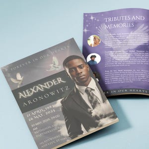 May include: A memorial card with the text "Forever in Our Hearts" and the name "Alexander Aronowitz." The card features a portrait of a man in a suit, doves, and dates. A second booklet is visible with the title "Tributes and Memories."