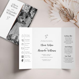 Könnte beinhalten: Eine dreifach gefaltete Hochzeitskarte in Weiß mit den Namen Olivia Wilson und Alexander Williams. Die Einladung enthält Veranstaltungsdetails, ein Foto des Paares und einen Zeitplan. Das Design ist elegant und minimalistisch.