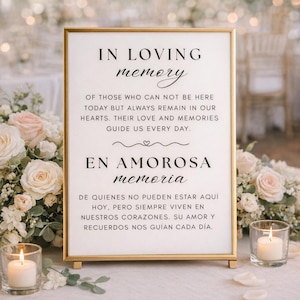 May include: A rectangular sign with gold frame, featuring the text "IN LOVING memory" in black script. The sign includes English and Spanish text about remembrance. The sign is surrounded by flowers and candles, creating a soft, romantic atmosphere.