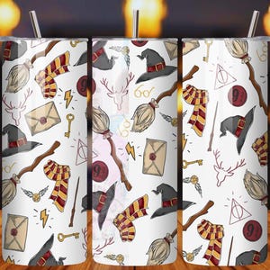 May include: White tumbler with a repeating pattern of wizarding school-themed illustrations. The design includes a black witch hat, a broom, a scarf, a key, and a letter. The tumbler has a silver straw.