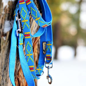May include: Blue dog leash with a decorative pattern of yellow, red, and white diamonds and crosses. The leash has a metal clasp and a loop for the owner's hand. The brand name "WILLTOGO.COM.UA" is visible on the leash.