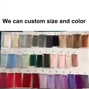 May include: A color chart displaying samples of fabric in various colors. The samples are arranged in rows and columns, with each sample labeled with a number. The text "We can custom size and color" is at the top.